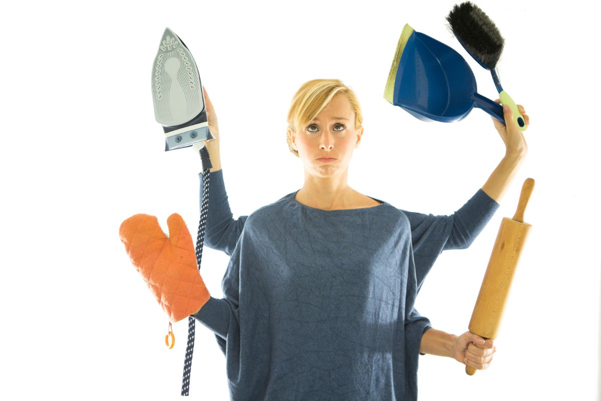 A woman with additional arms photoshopped, holding various household cooking and cleaning utensils